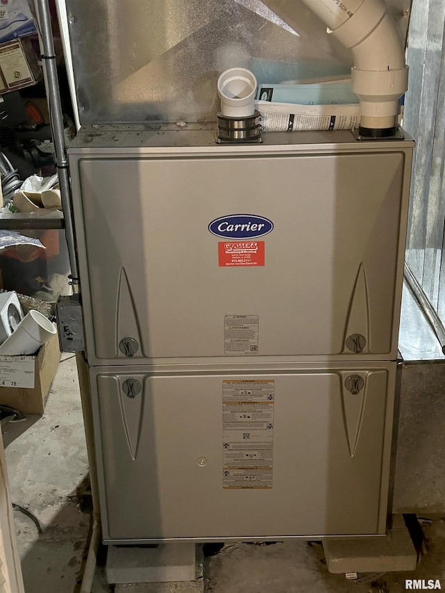 utility room featuring heating unit