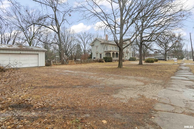 view of yard with a garage and an outdoor structure