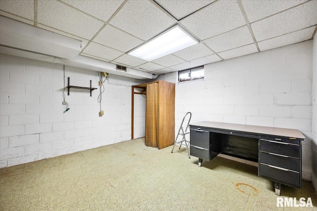 basement with a paneled ceiling