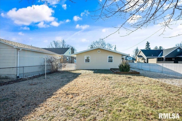 rear view of property featuring a yard