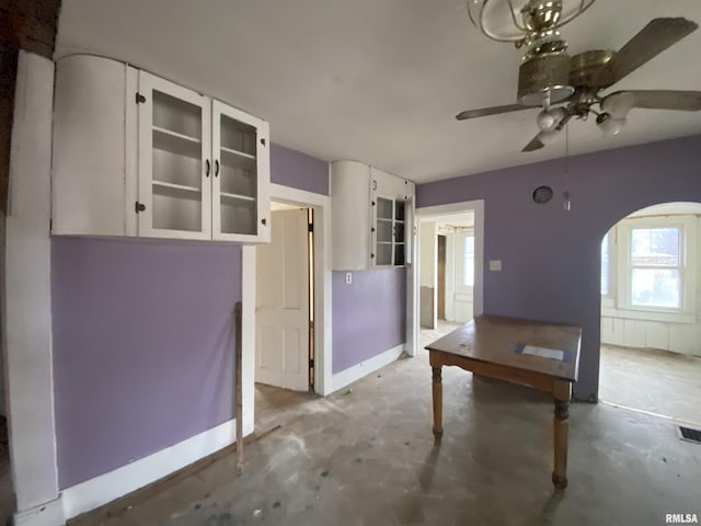 interior space featuring concrete flooring and ceiling fan