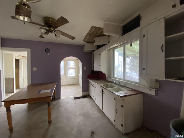 kitchen featuring sink, white cabinets, and ceiling fan