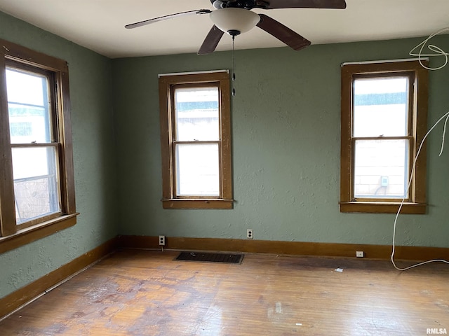 unfurnished room with wood-type flooring and ceiling fan