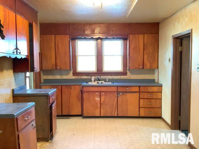 kitchen featuring sink and a textured ceiling