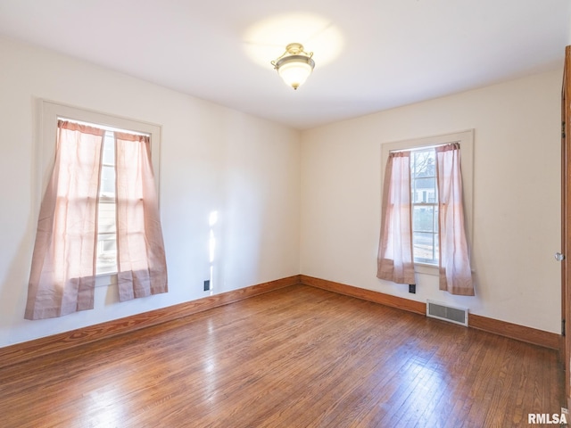 spare room featuring dark wood-type flooring