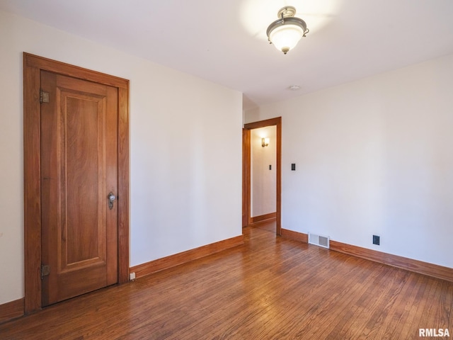 empty room with wood-type flooring