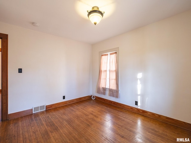 spare room featuring dark wood-type flooring