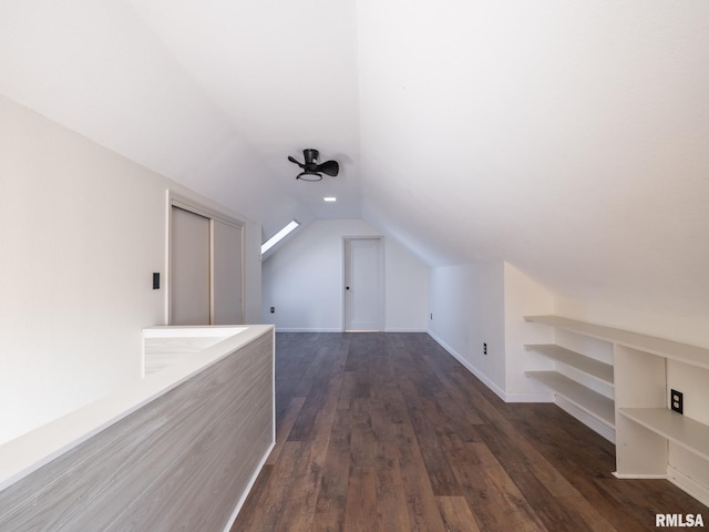 bonus room featuring lofted ceiling and dark hardwood / wood-style floors