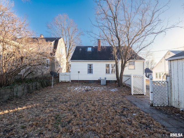 rear view of property featuring central air condition unit