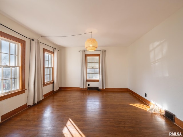 unfurnished room featuring dark hardwood / wood-style flooring