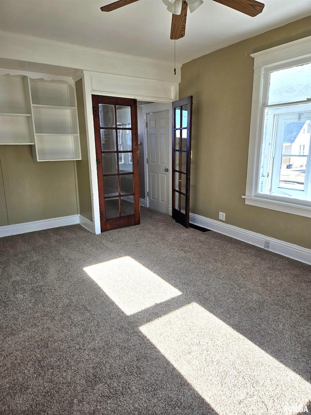 carpeted empty room with french doors and ceiling fan