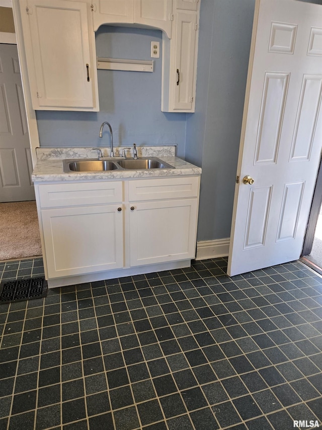 kitchen with white cabinetry and sink