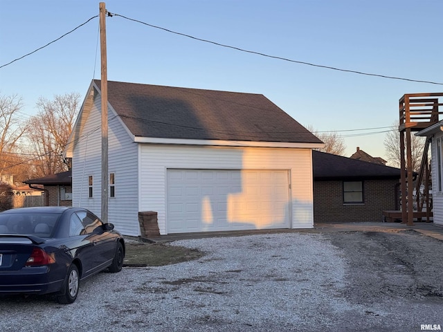 view of garage at dusk