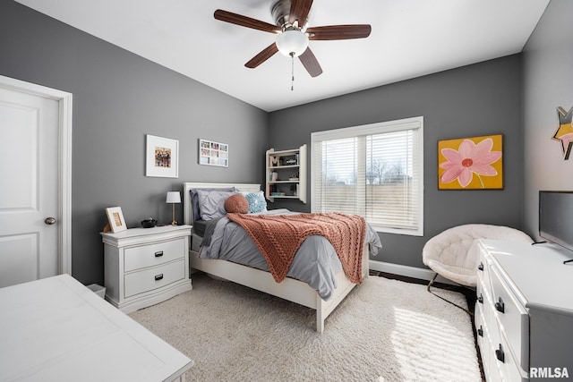 bedroom with a ceiling fan and baseboards