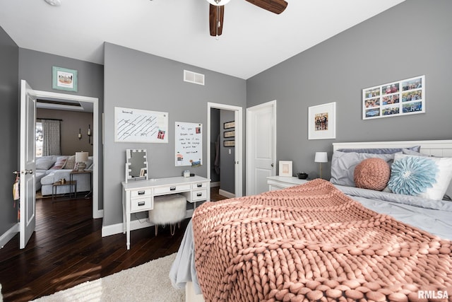 bedroom featuring a ceiling fan, baseboards, visible vents, and dark wood-type flooring