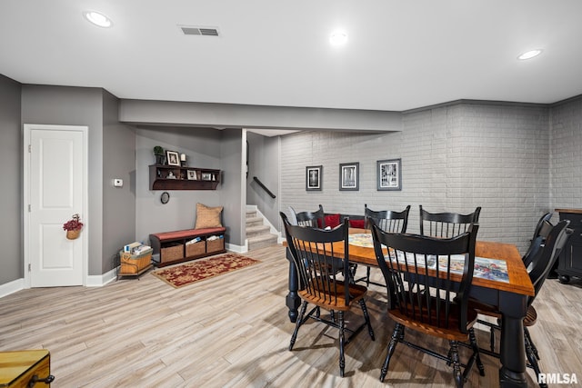 dining area featuring visible vents, baseboards, light wood-style flooring, stairway, and recessed lighting