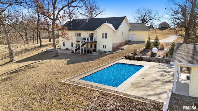 back of house featuring a patio area, an outdoor pool, and stairs