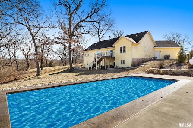 pool with a deck and stairs