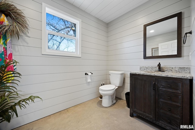 half bathroom featuring toilet and vanity