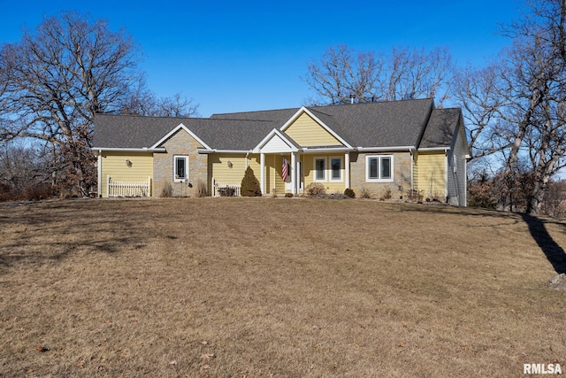 ranch-style home with stone siding and a front lawn