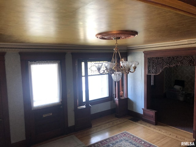 foyer featuring hardwood / wood-style flooring and an inviting chandelier