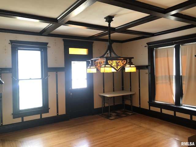 foyer entrance featuring plenty of natural light, coffered ceiling, and light wood-type flooring