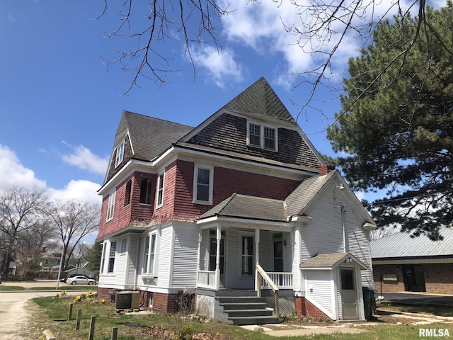 view of front of house featuring a porch and central air condition unit