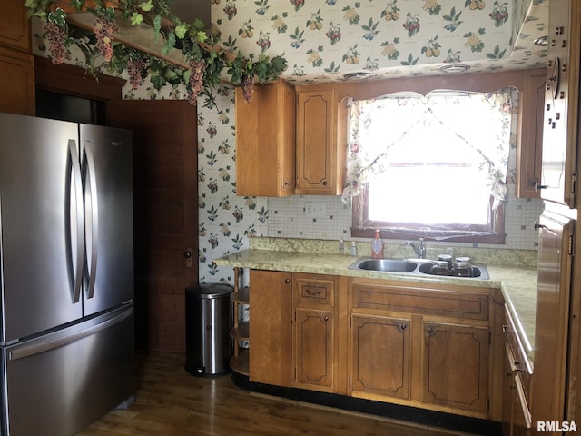 kitchen with stainless steel refrigerator, dark hardwood / wood-style flooring, sink, and decorative backsplash