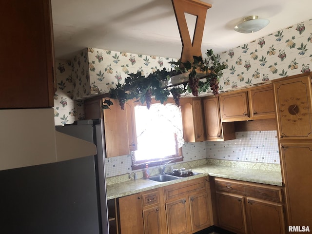 kitchen with sink, stainless steel fridge, and decorative backsplash