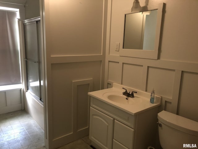 full bathroom featuring toilet, vanity, and shower / bath combination with glass door