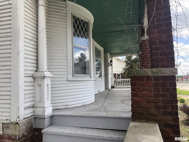 view of exterior entry featuring a porch