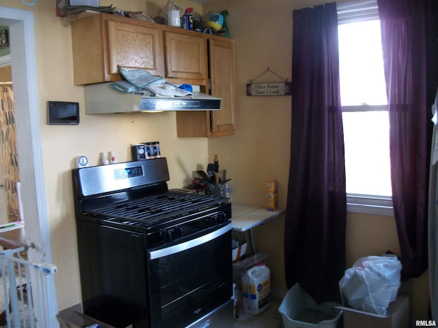 kitchen featuring tile countertops, a wealth of natural light, and stainless steel gas stove