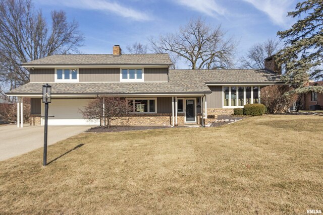 view of front facade with a garage and a front lawn