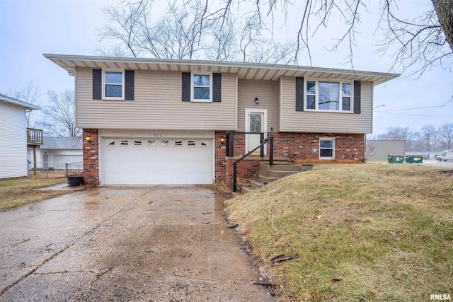 split foyer home with a garage and a front lawn