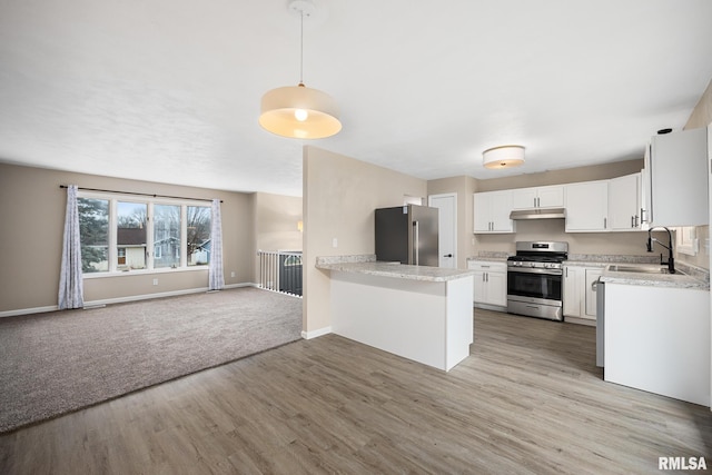 kitchen with white cabinetry, appliances with stainless steel finishes, pendant lighting, and kitchen peninsula