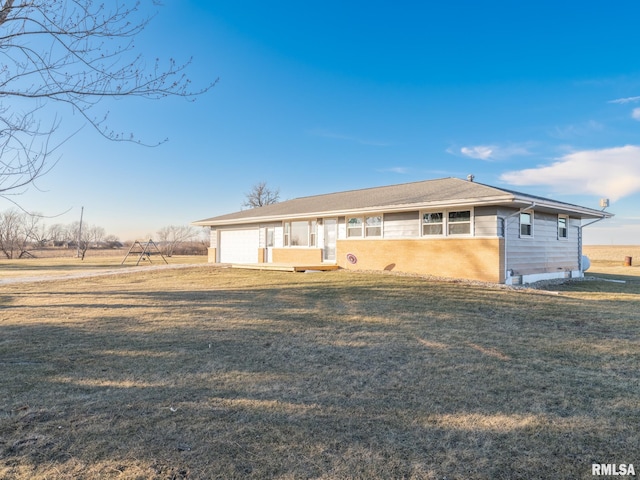 ranch-style house with a garage and a front lawn