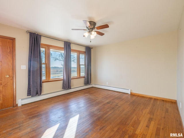 unfurnished room featuring ceiling fan, wood-type flooring, and a baseboard radiator