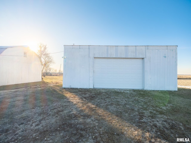 view of garage at dusk