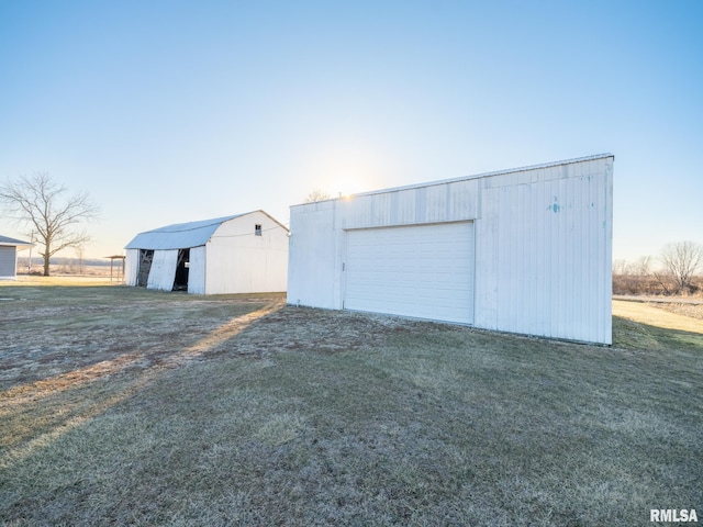 garage at dusk with a lawn