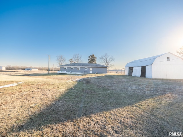 view of front facade with an outbuilding and a front yard