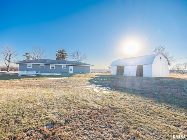 ranch-style home featuring an outbuilding and a front yard