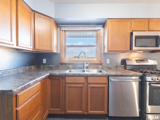 kitchen with tasteful backsplash, appliances with stainless steel finishes, and sink