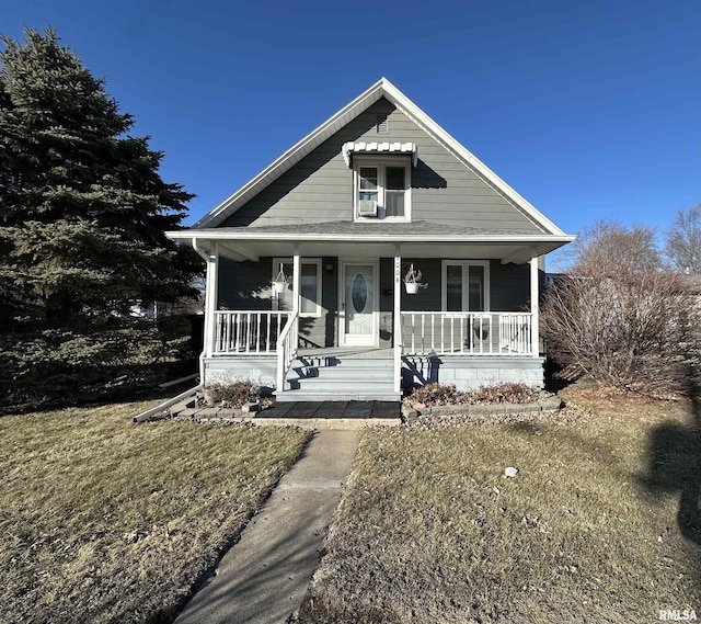 view of front of property with covered porch and a front yard