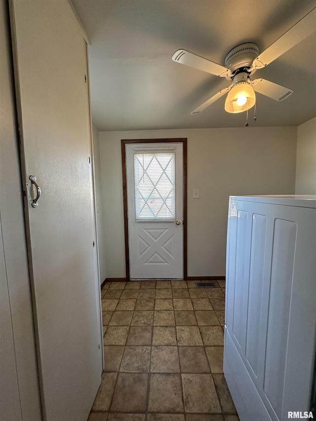 doorway to outside featuring washer / dryer and ceiling fan