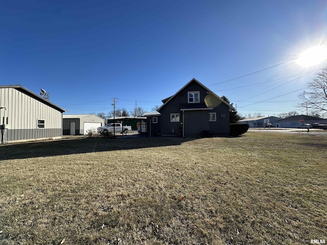 exterior space with an outbuilding, a carport, a garage, and a yard