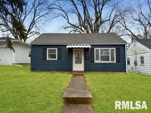 bungalow-style home with a garage and a front yard