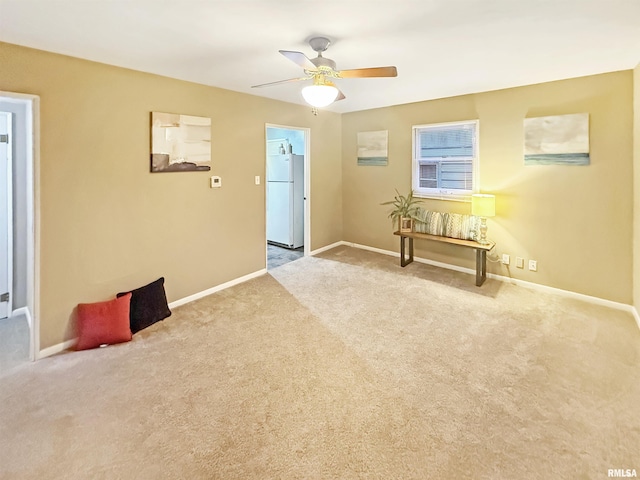 interior space featuring light colored carpet and ceiling fan