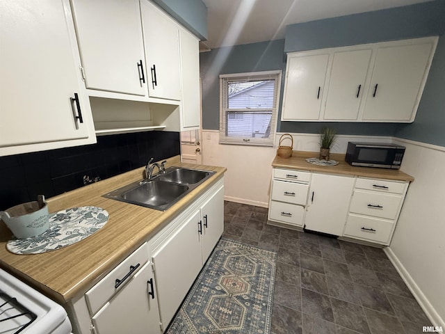 kitchen with white cabinetry, sink, and decorative backsplash