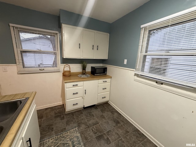 kitchen with white cabinetry and sink