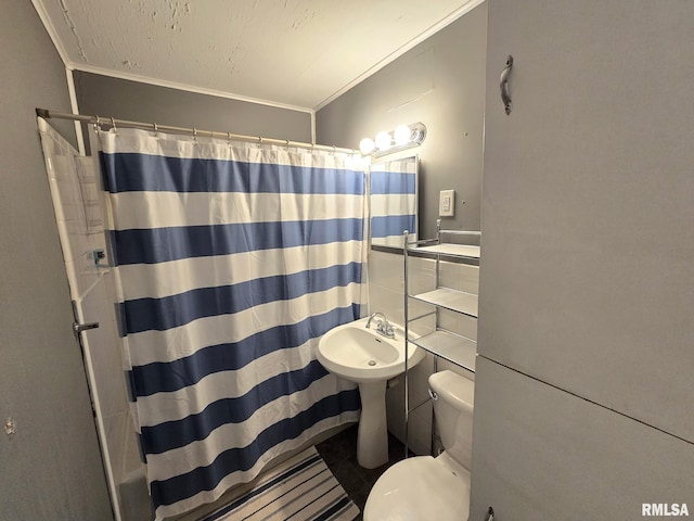 bathroom featuring ornamental molding, toilet, and walk in shower